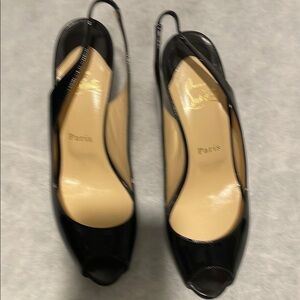 Christian Louboutin black patent leather sling back peep toe heel.